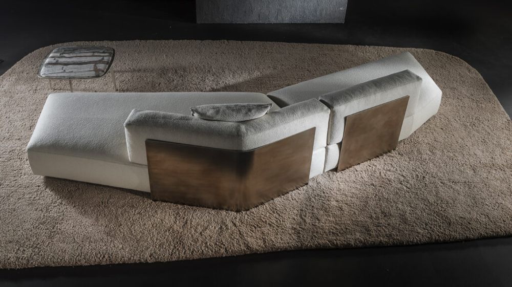 White bouclé chaise sectional sofa with bronze panel accents