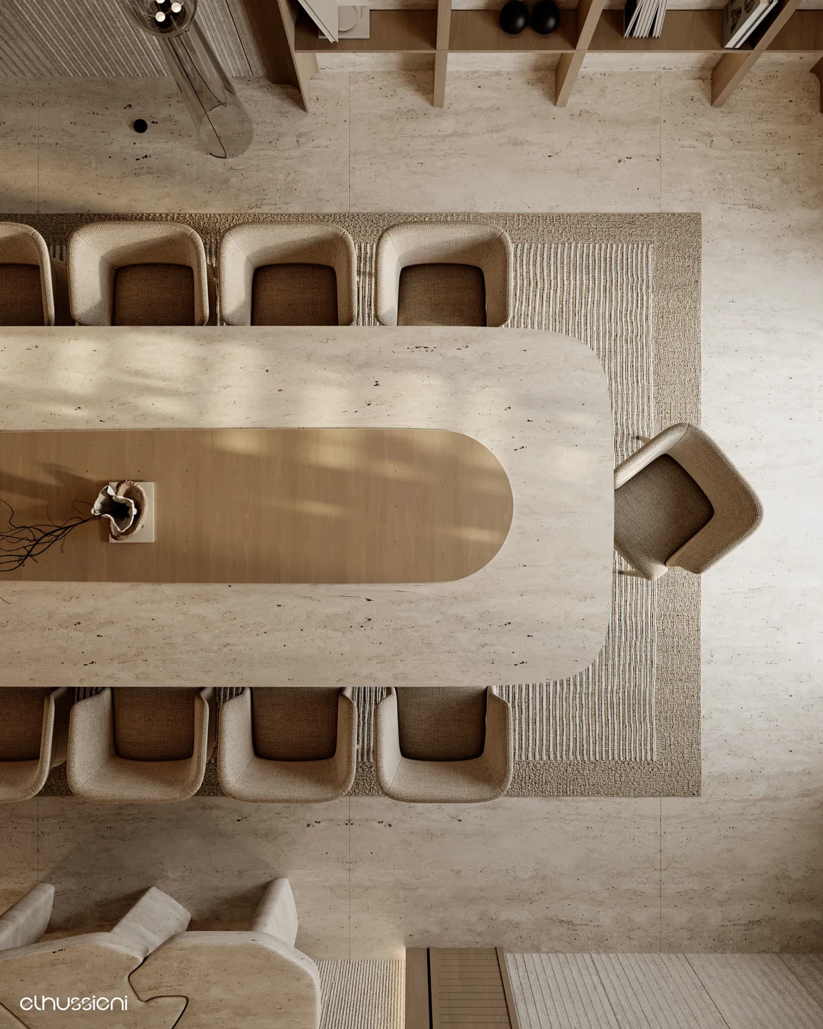 Aerial view of oval travertine dining table with curved chairs